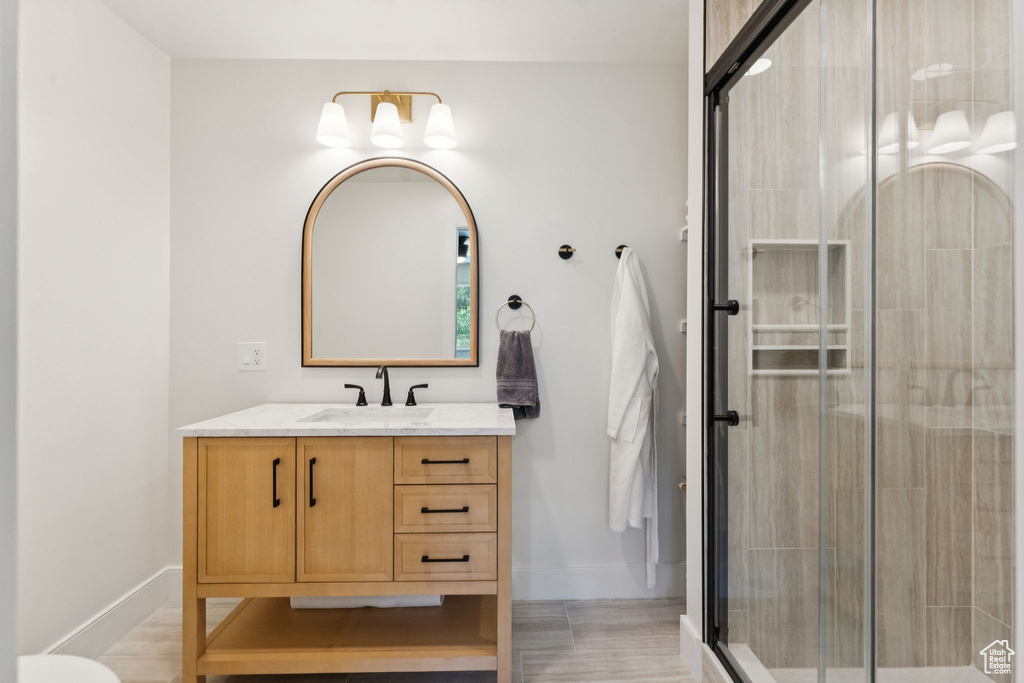 Full bathroom with vanity and a stall shower