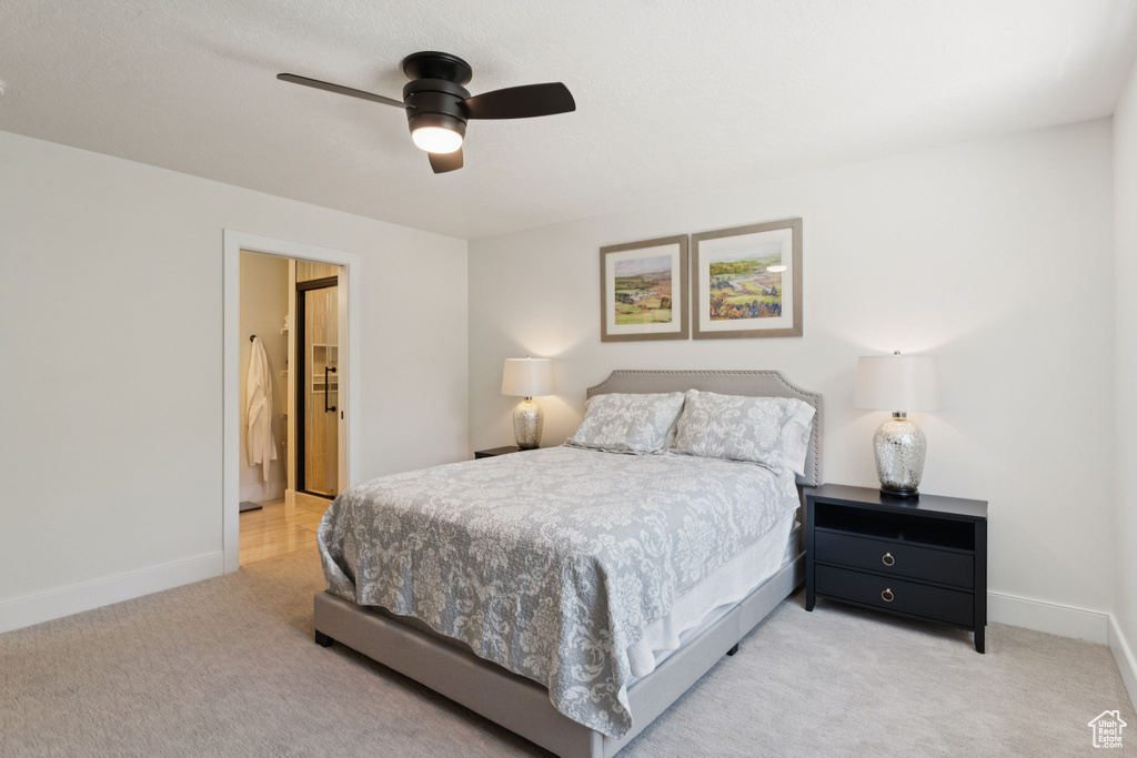 Bedroom featuring light carpet and a ceiling fan
