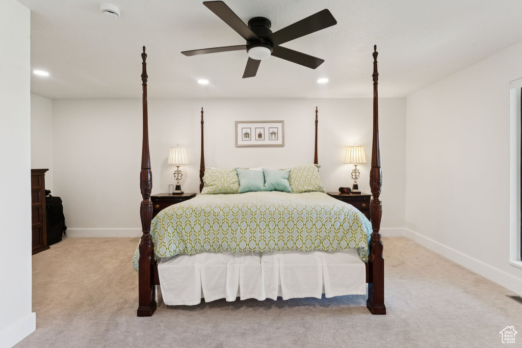 Carpeted bedroom featuring recessed lighting and a ceiling fan