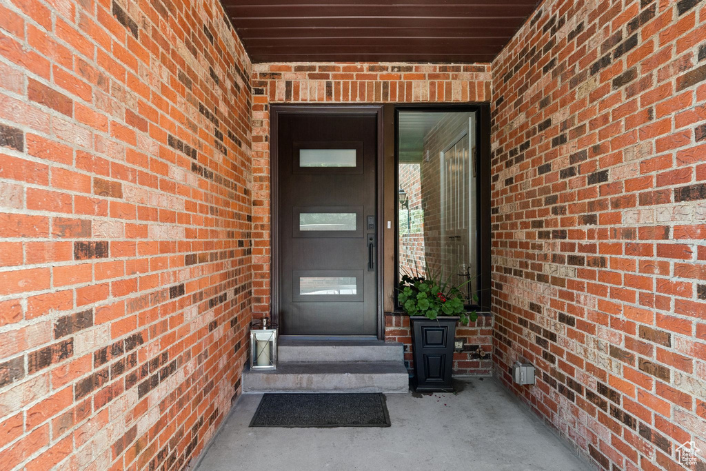 Doorway to property with brick siding
