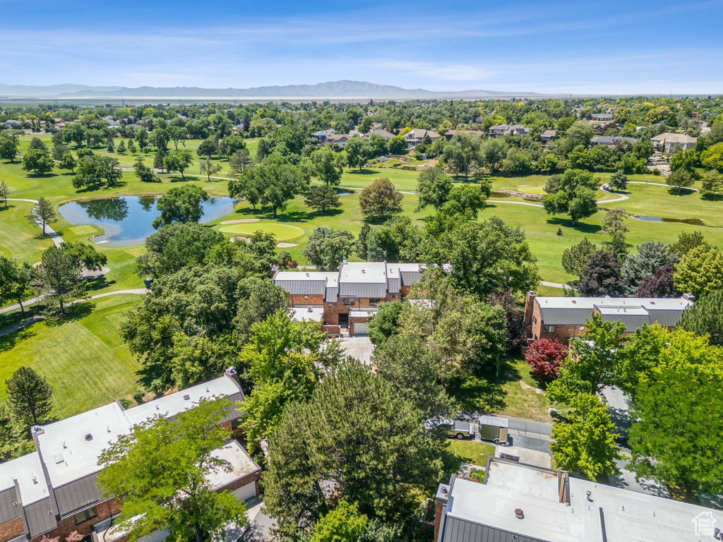 Aerial view of residential area with a water and mountain view and a golf course