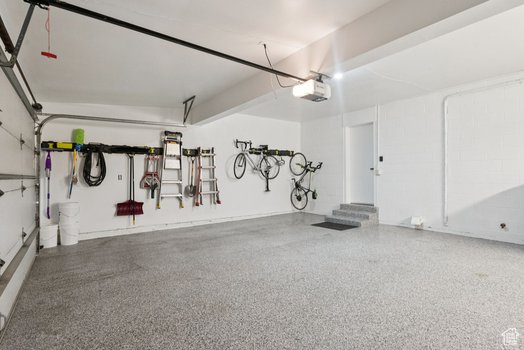 Garage with a garage door opener and concrete block wall