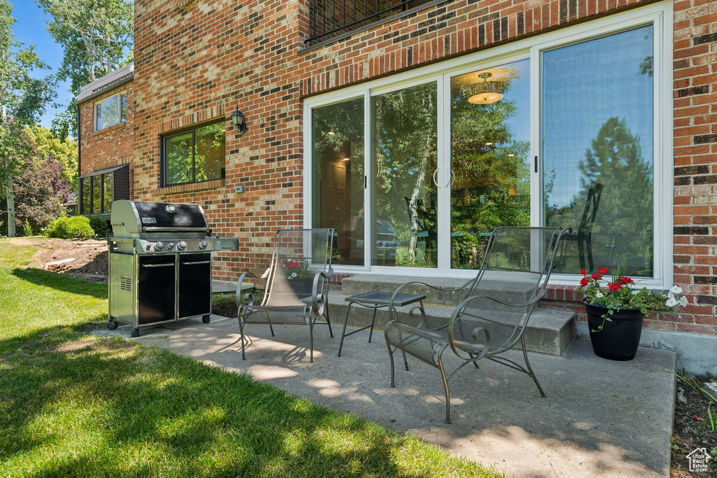 View of patio with a grill