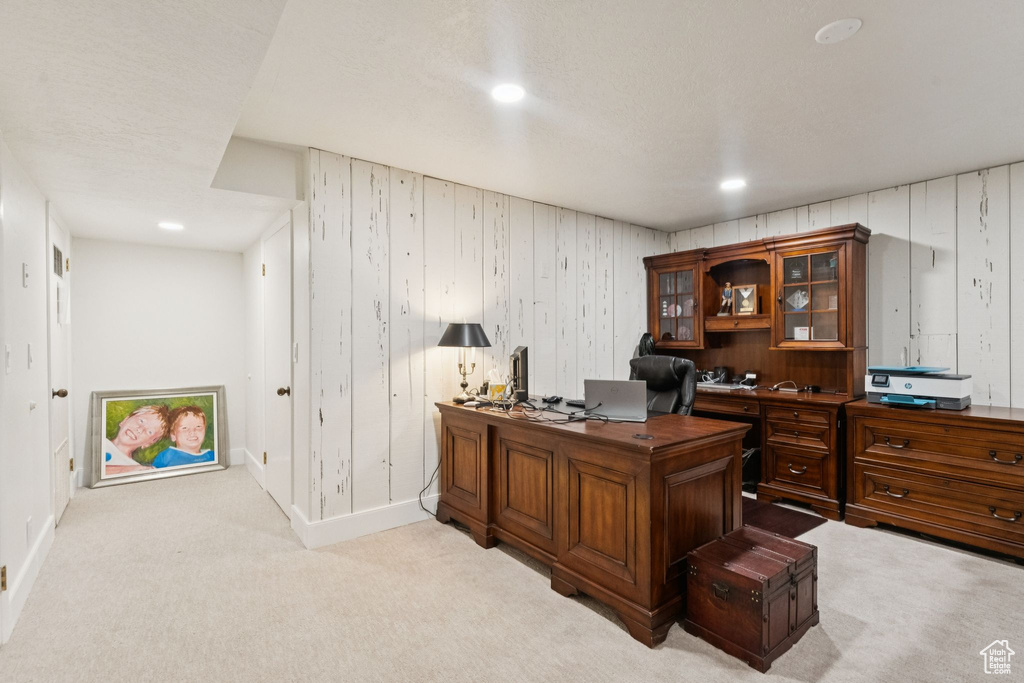 Office area with light colored carpet, recessed lighting, and wooden walls