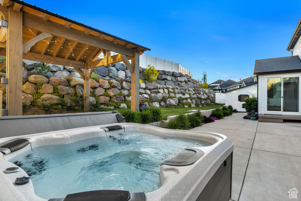 View of swimming pool with a hot tub, a gazebo, and a patio