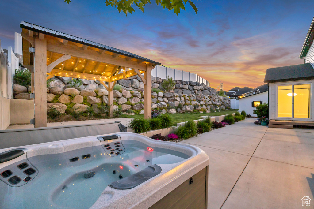 View of patio / terrace featuring a hot tub and a gazebo