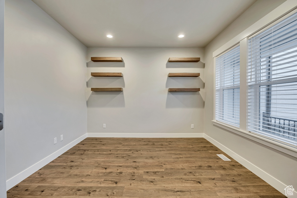 Empty room featuring wood finished floors and recessed lighting