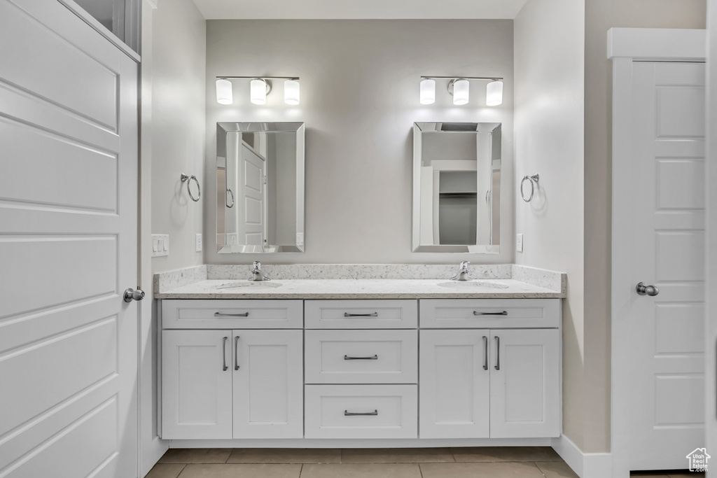 Bathroom featuring double vanity and tile patterned flooring