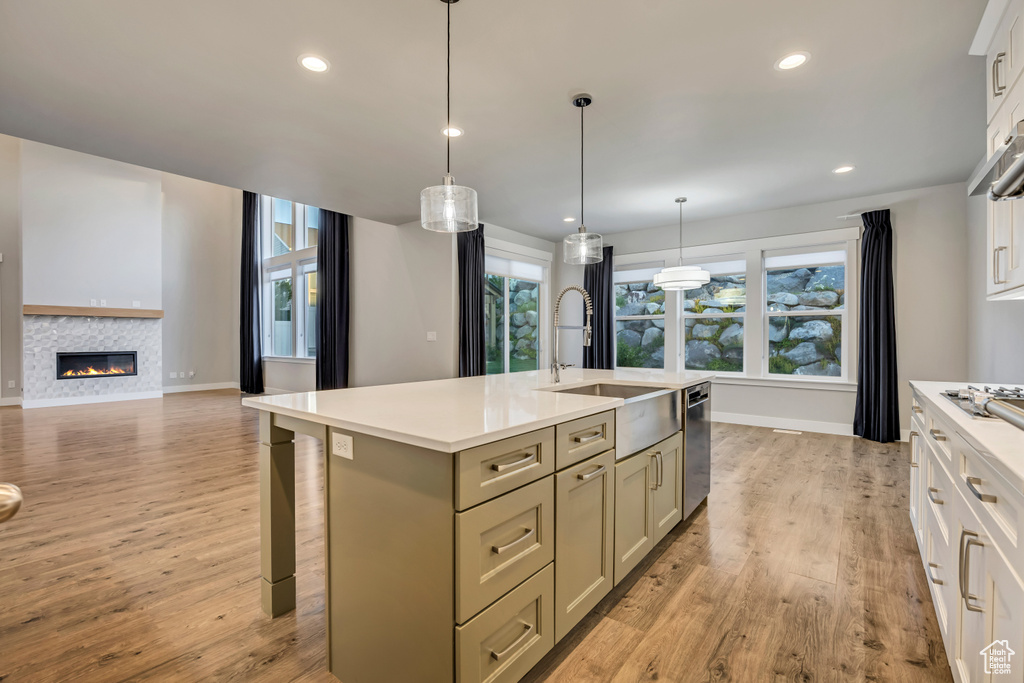 Kitchen with light countertops, healthy amount of natural light, light wood-style flooring, and recessed lighting