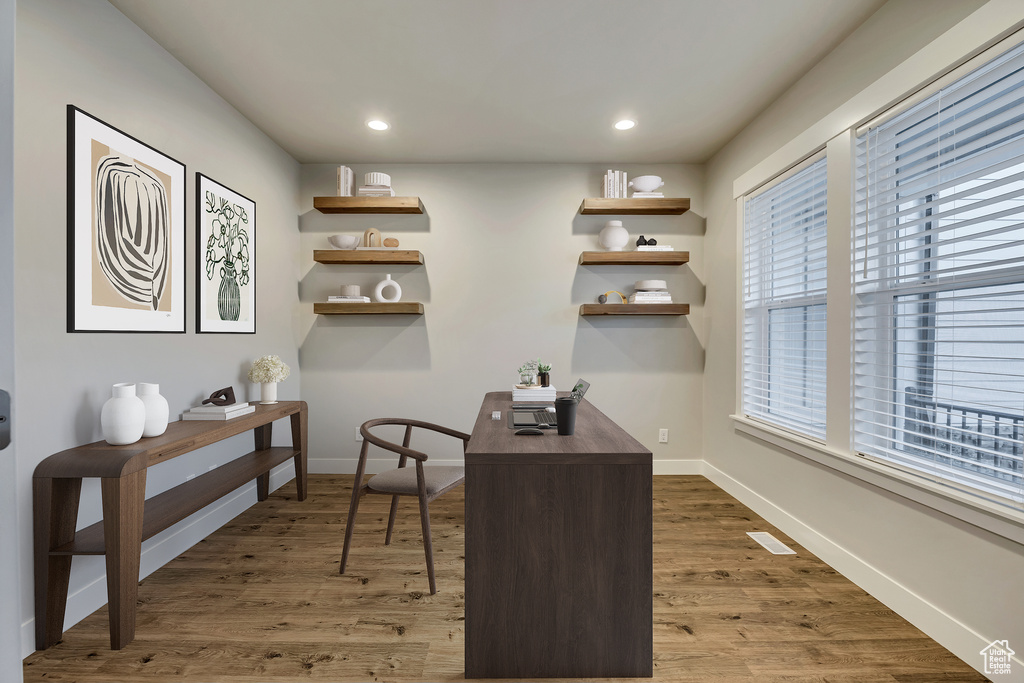 Office space featuring wood finished floors and recessed lighting