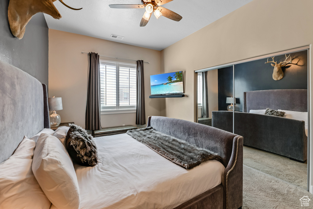 Bedroom with carpet and a ceiling fan
