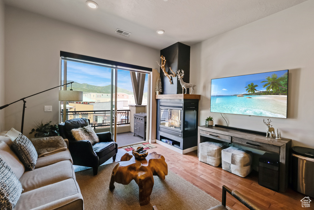 Living room featuring hardwood / wood-style flooring and recessed lighting
