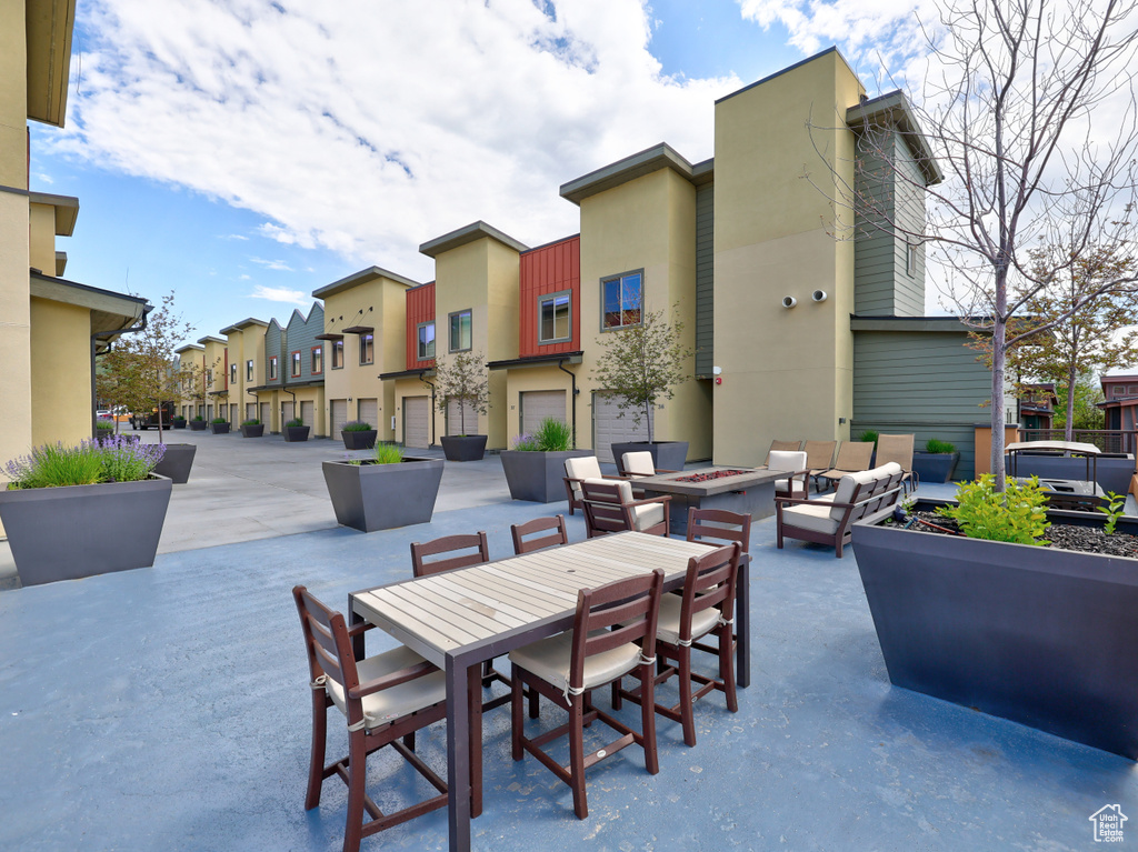 View of patio with a residential view and an outdoor living space with a fire pit
