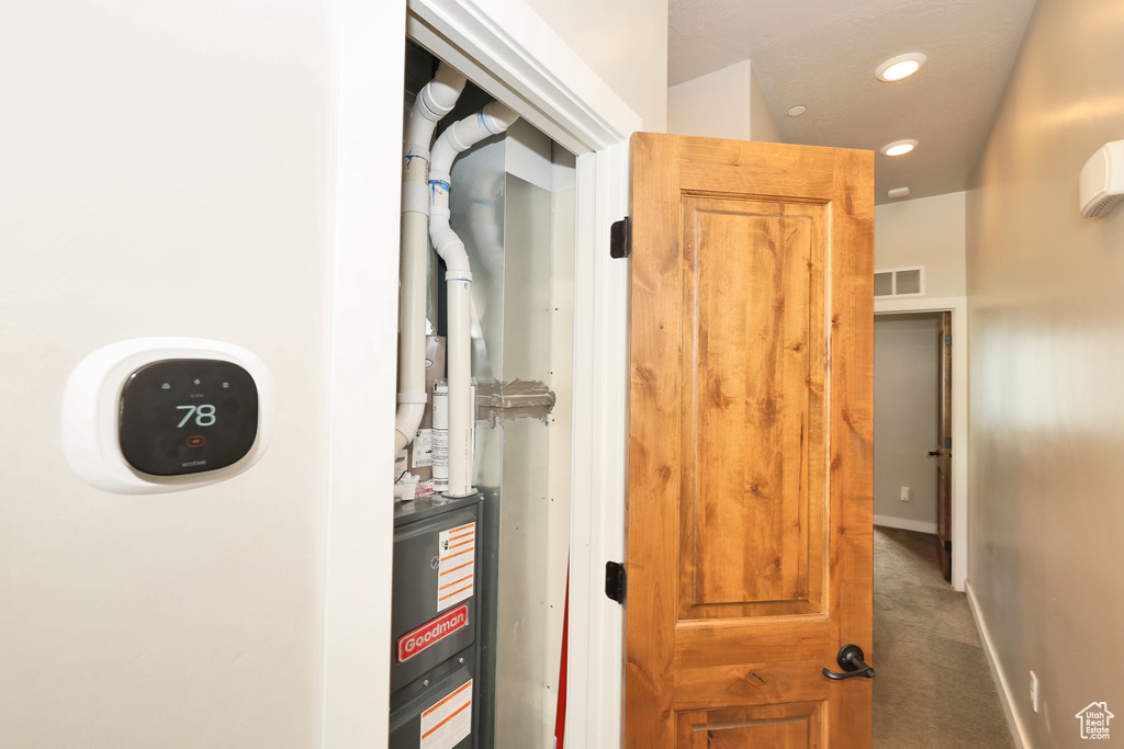 Corridor with recessed lighting and carpet floors