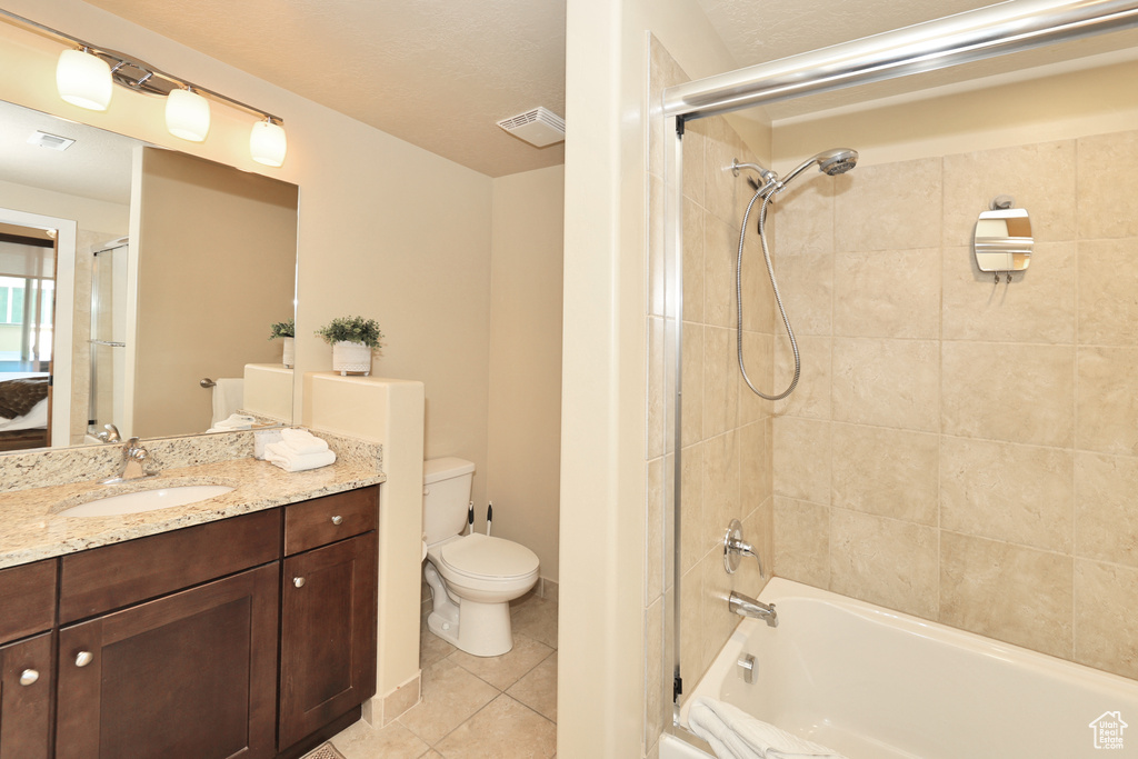 Bathroom featuring vanity, tile patterned flooring, and tub / shower combination