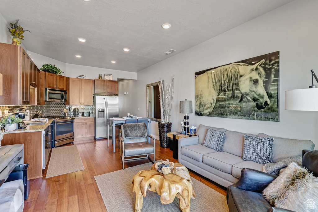 Living area featuring recessed lighting and light wood-type flooring