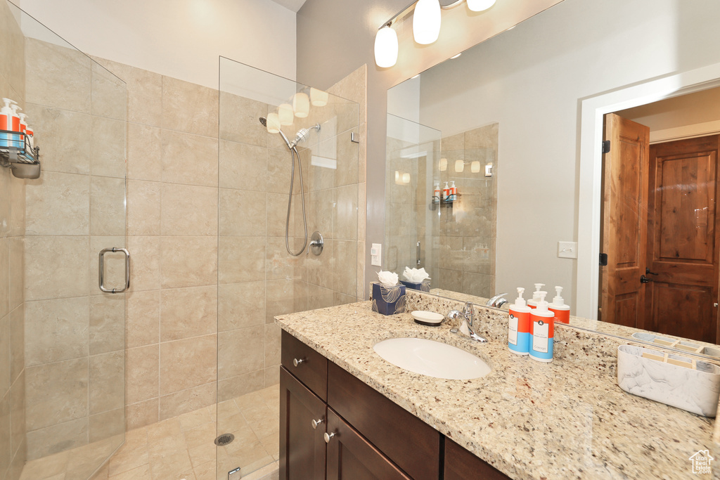 Bathroom featuring vanity and a shower stall