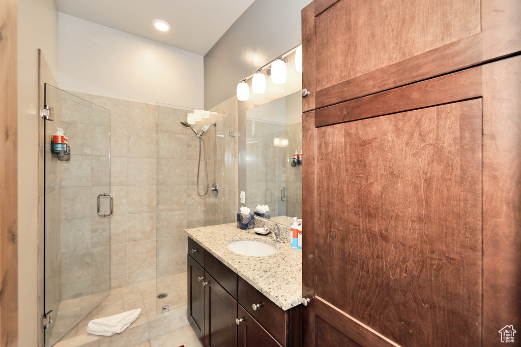 Full bathroom with vanity and a stall shower