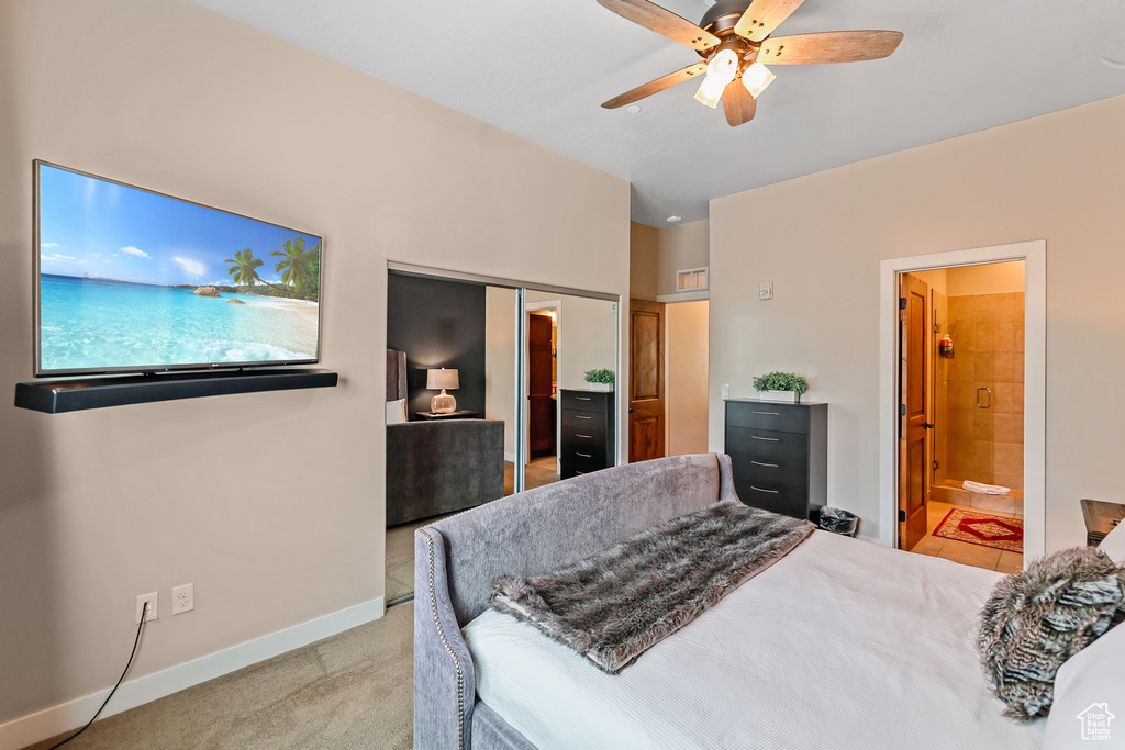 Bedroom featuring a closet, connected bathroom, ceiling fan, and carpet flooring