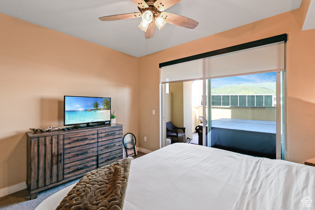 Carpeted bedroom featuring baseboards and a ceiling fan