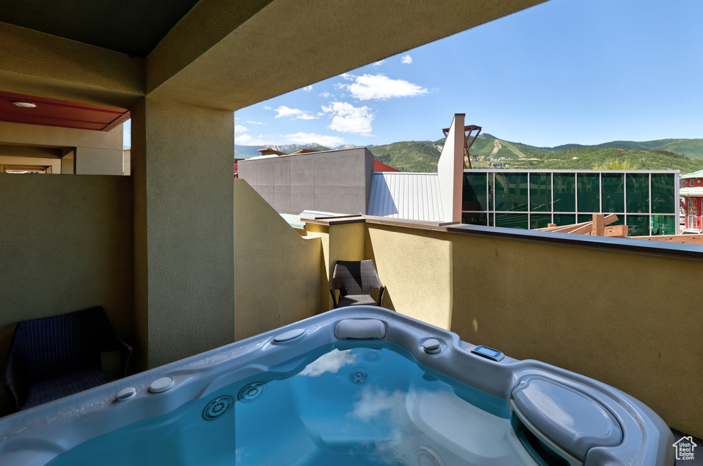 Patio / terrace with a mountain view and a hot tub