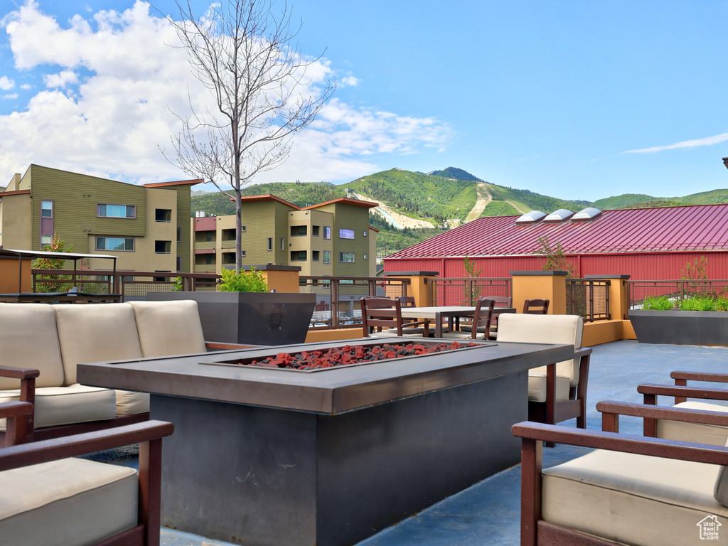 View of patio / terrace with a mountain view and an outdoor living space with a fire pit