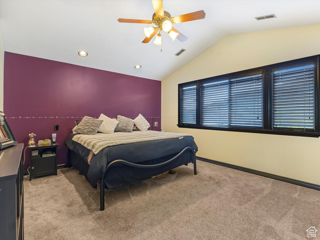 Carpeted bedroom with lofted ceiling, ceiling fan, and recessed lighting