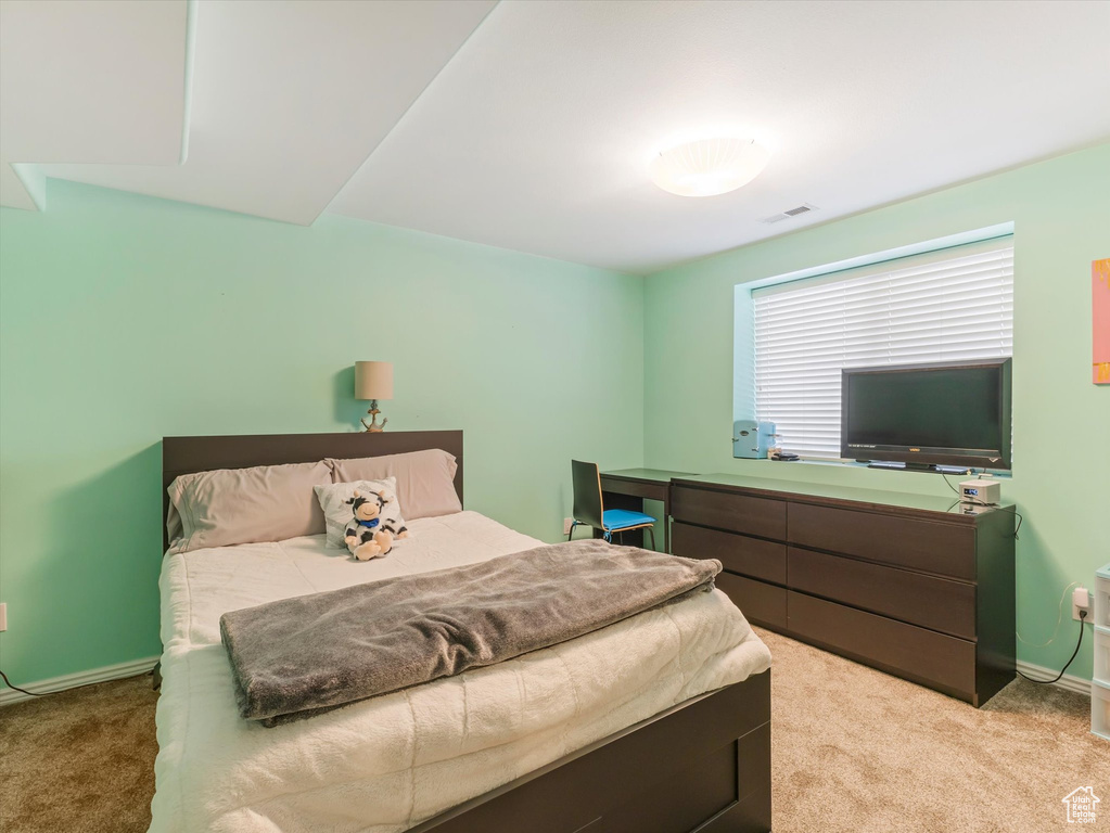 Carpeted bedroom featuring baseboards