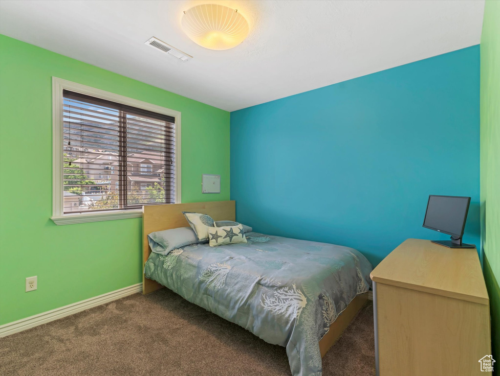 Bedroom with carpet flooring and baseboards