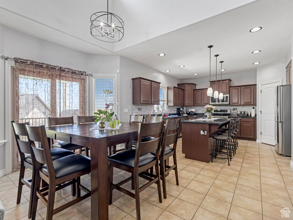 Dining space featuring a chandelier, light tile patterned floors, and recessed lighting