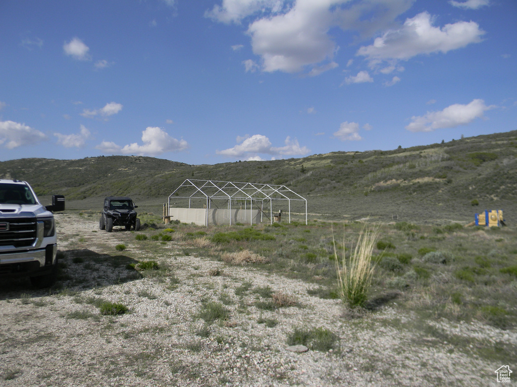 View of yard with a mountain view and an outdoor structure