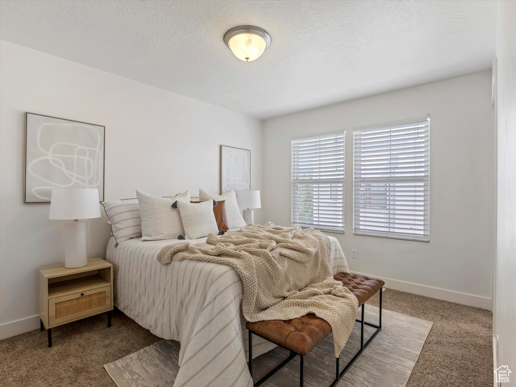 Carpeted bedroom featuring baseboards