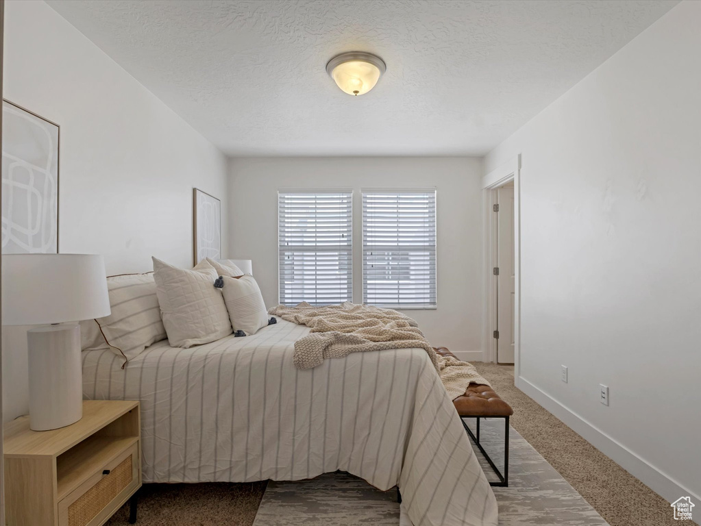 Carpeted bedroom featuring baseboards