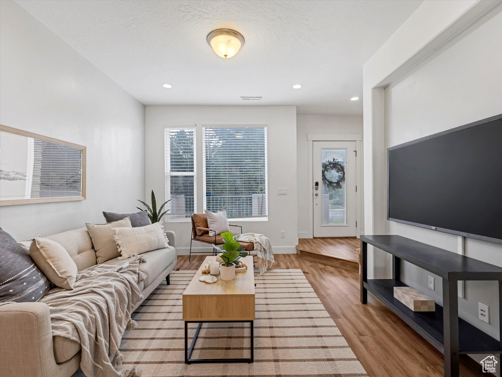 Living room with wood finished floors and recessed lighting