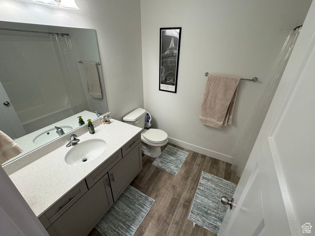 Full bathroom with vanity and wood finished floors