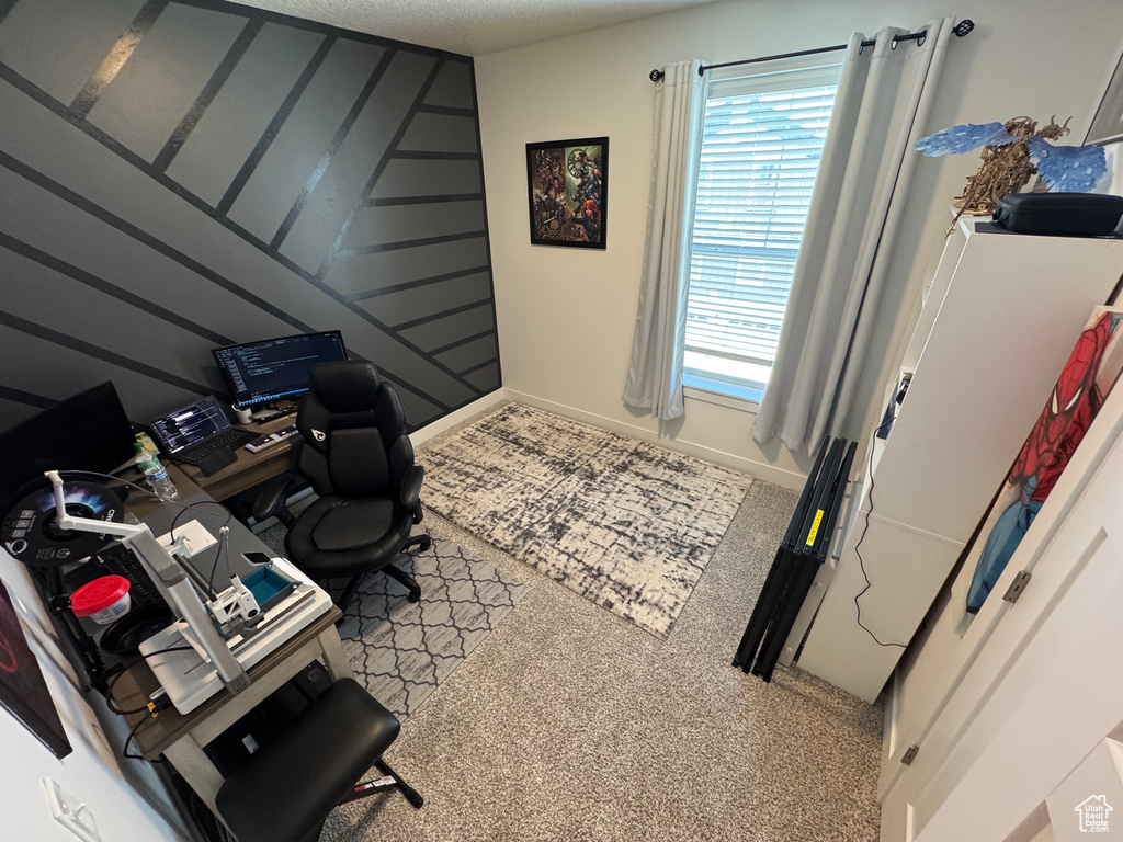 Home office with plenty of natural light and carpet floors