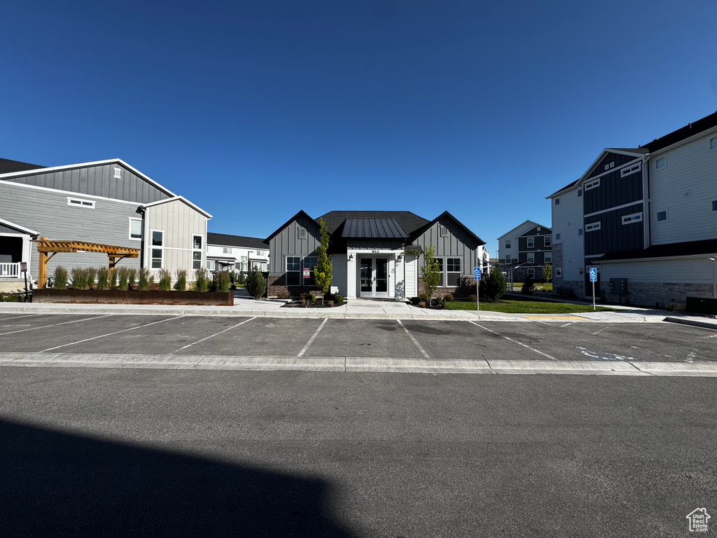 Uncovered parking lot with french doors and a residential view