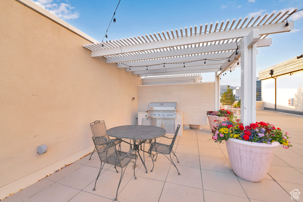 View of patio featuring a pergola, outdoor dining space, and area for grilling