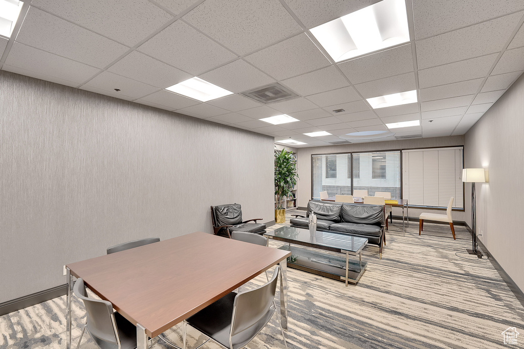 Home office featuring a drop ceiling and carpet