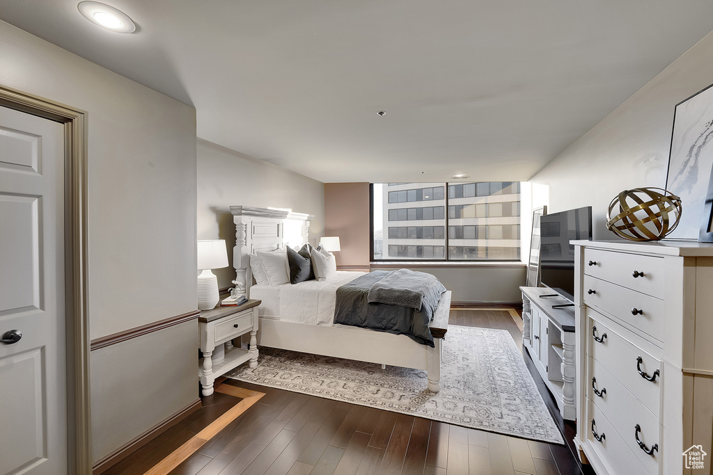 Bedroom with dark wood-style flooring