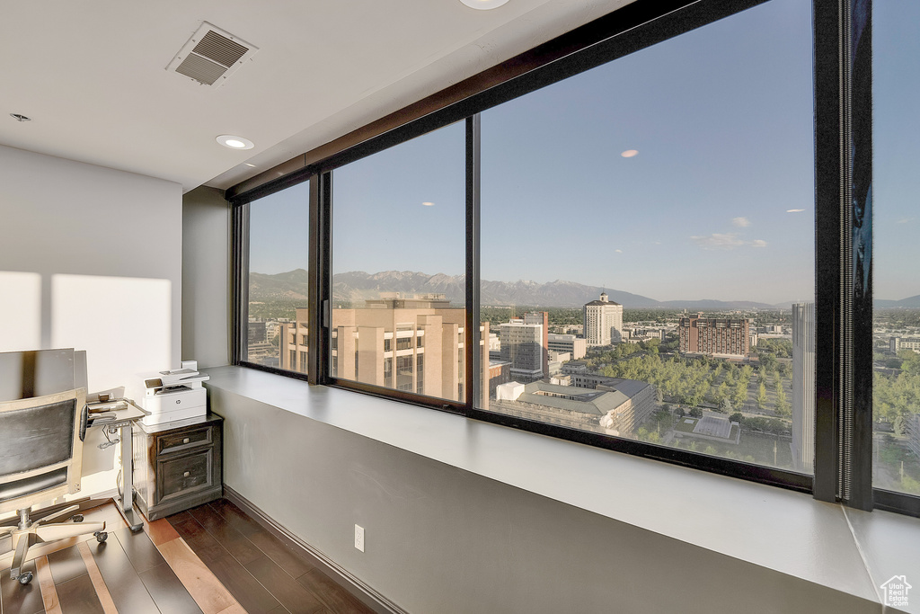 Office area with a mountain view, wood finished floors, and plenty of natural light