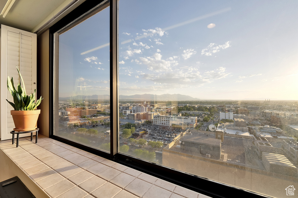 Interior space with a view of city and a mountainous background