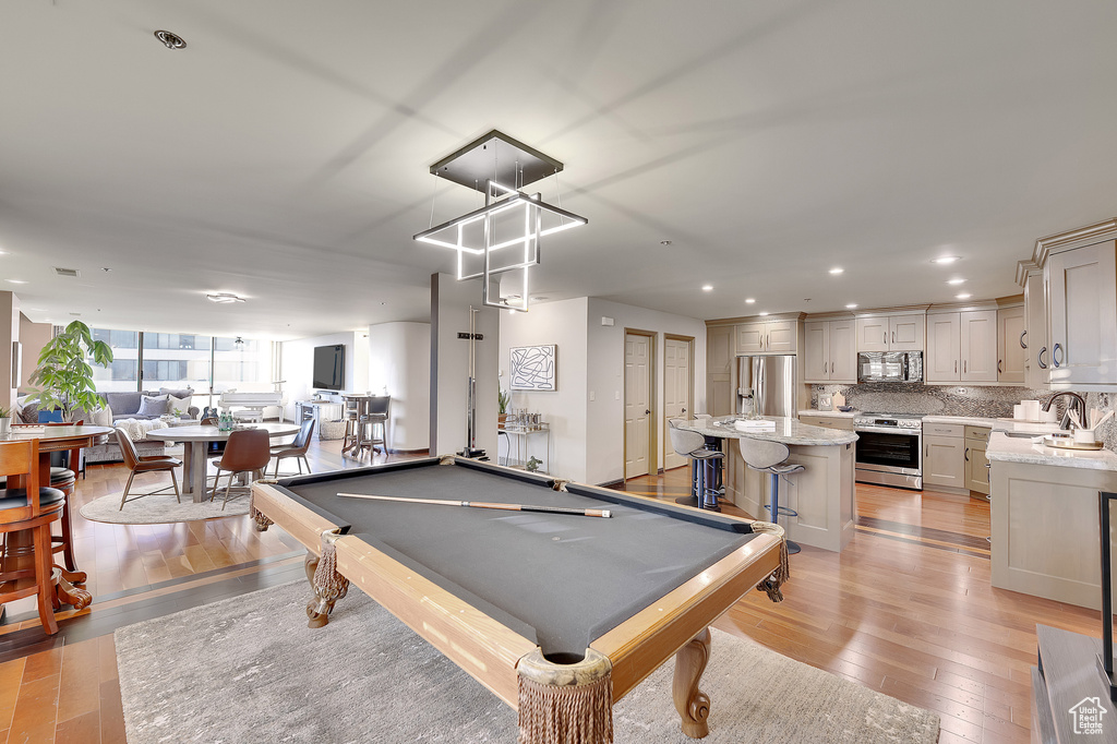 Playroom featuring light wood finished floors, pool table, and recessed lighting
