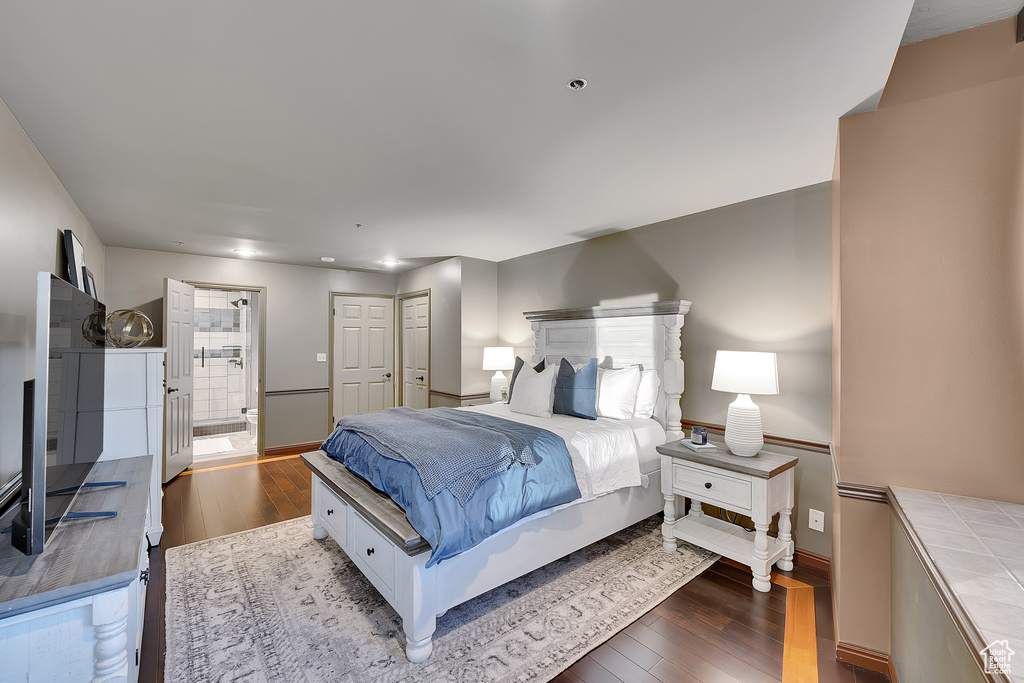 Bedroom with wood finished floors and ensuite bath