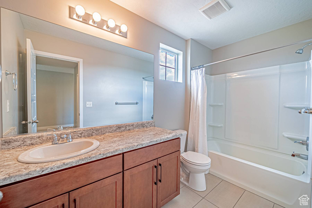 Full bath featuring vanity, tile patterned floors, and shower / bathtub combination with curtain