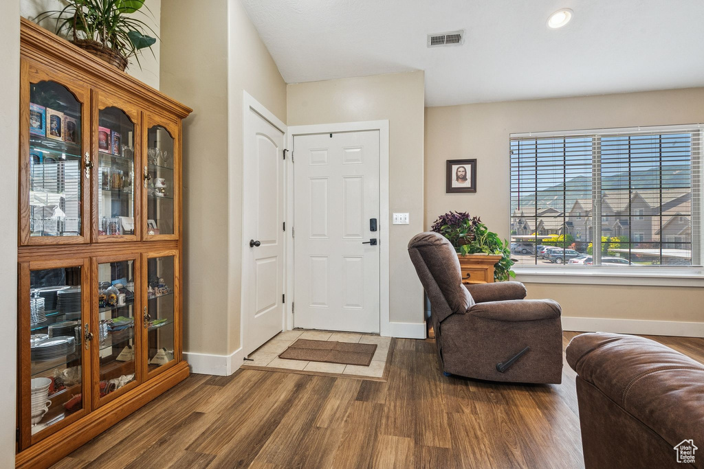 Foyer with wood finished floors and recessed lighting