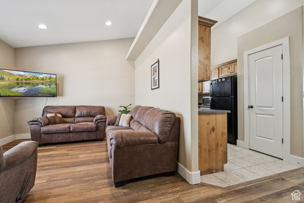 Living room with light wood-style floors and recessed lighting