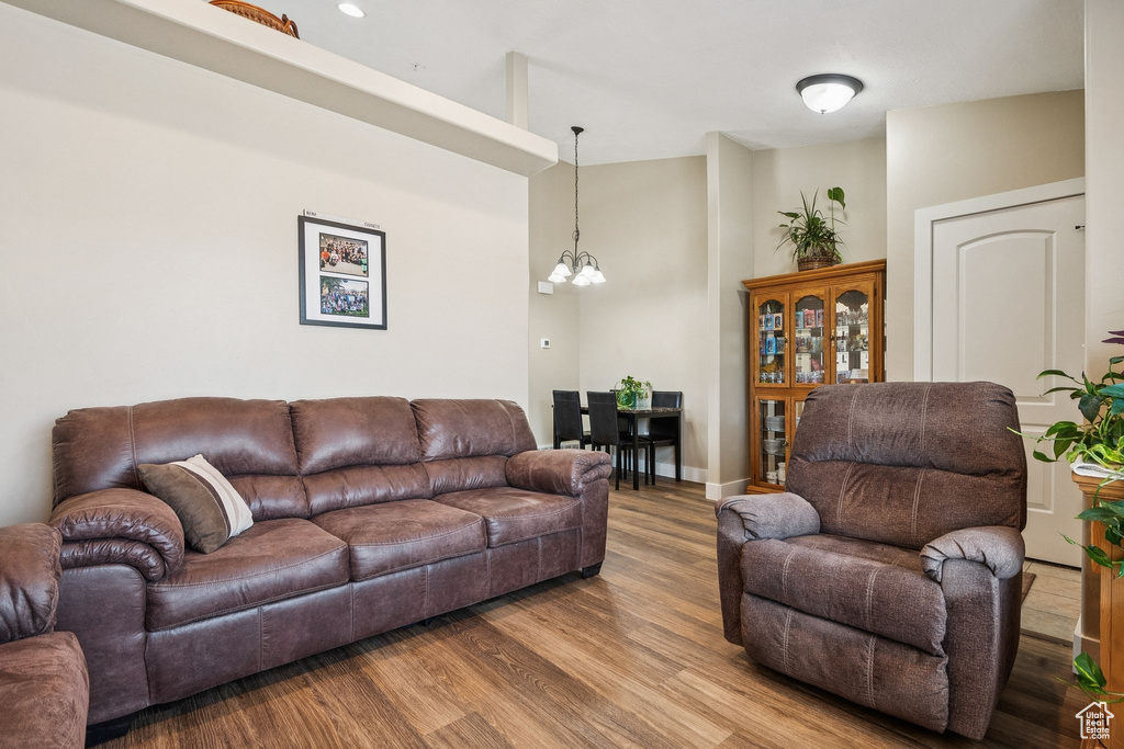 Living area with a chandelier and wood finished floors