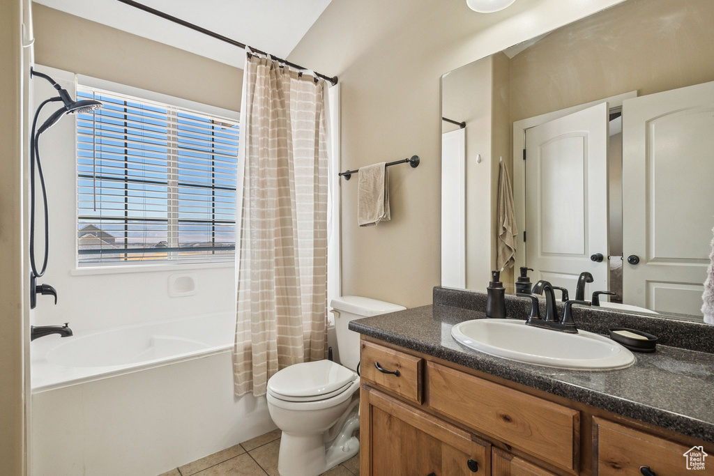 Full bath featuring vanity, shower / bath combination with curtain, tile patterned flooring, and healthy amount of natural light