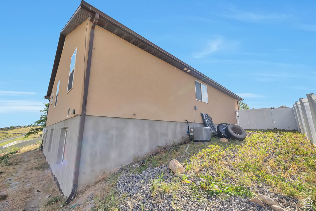View of side of home featuring stucco siding